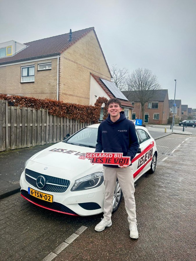 Geslaagde leerling bij de lesauto van Rijschool Les je Vrij in het Westland